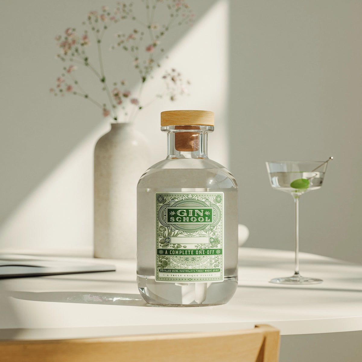 Gin School custom-distilled gin bottle with martini cocktail and flowers on a Brisbane café table
